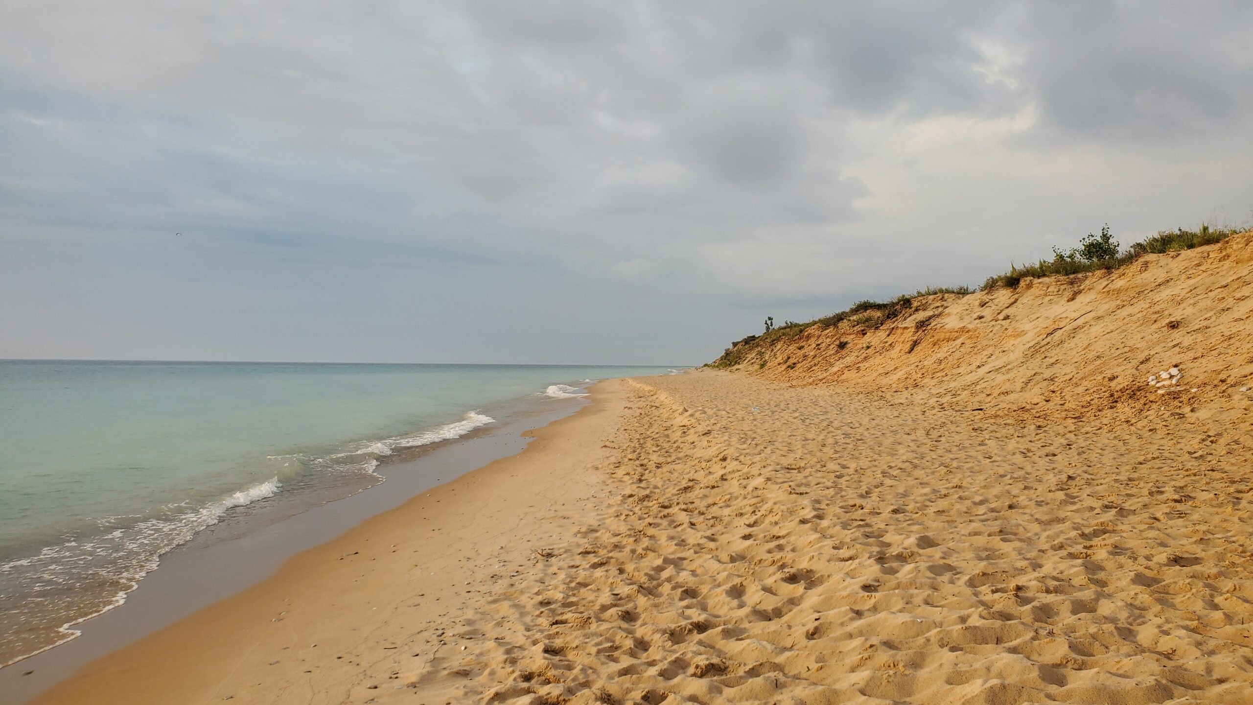 Beach scene with sand an lake waves