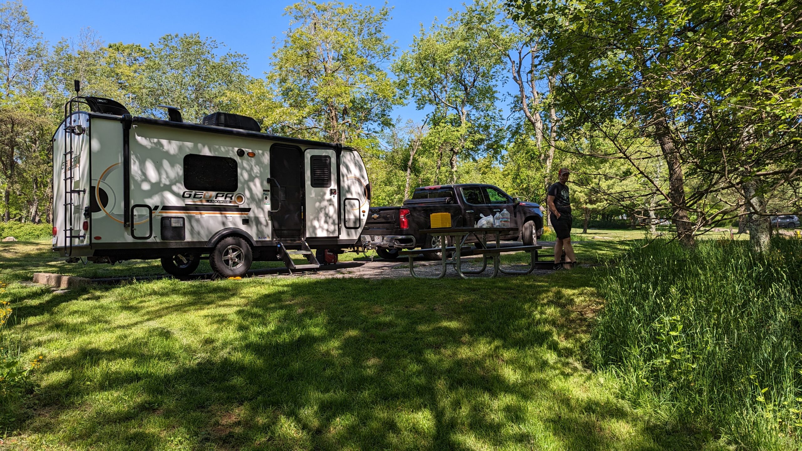 A travel trailer and pick up truck in a campsite at Big Meadows Campground in Shenandoah National Park