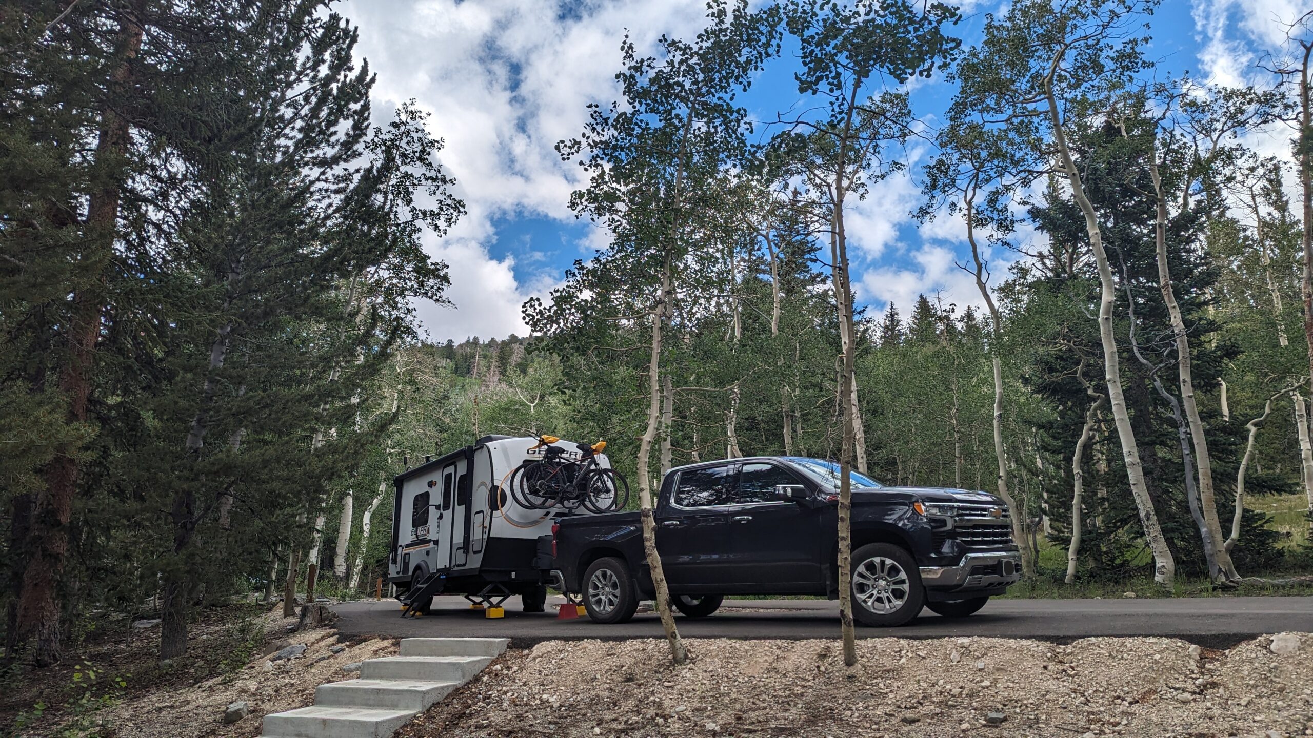 Pickup truck and travel trailer in a campsite