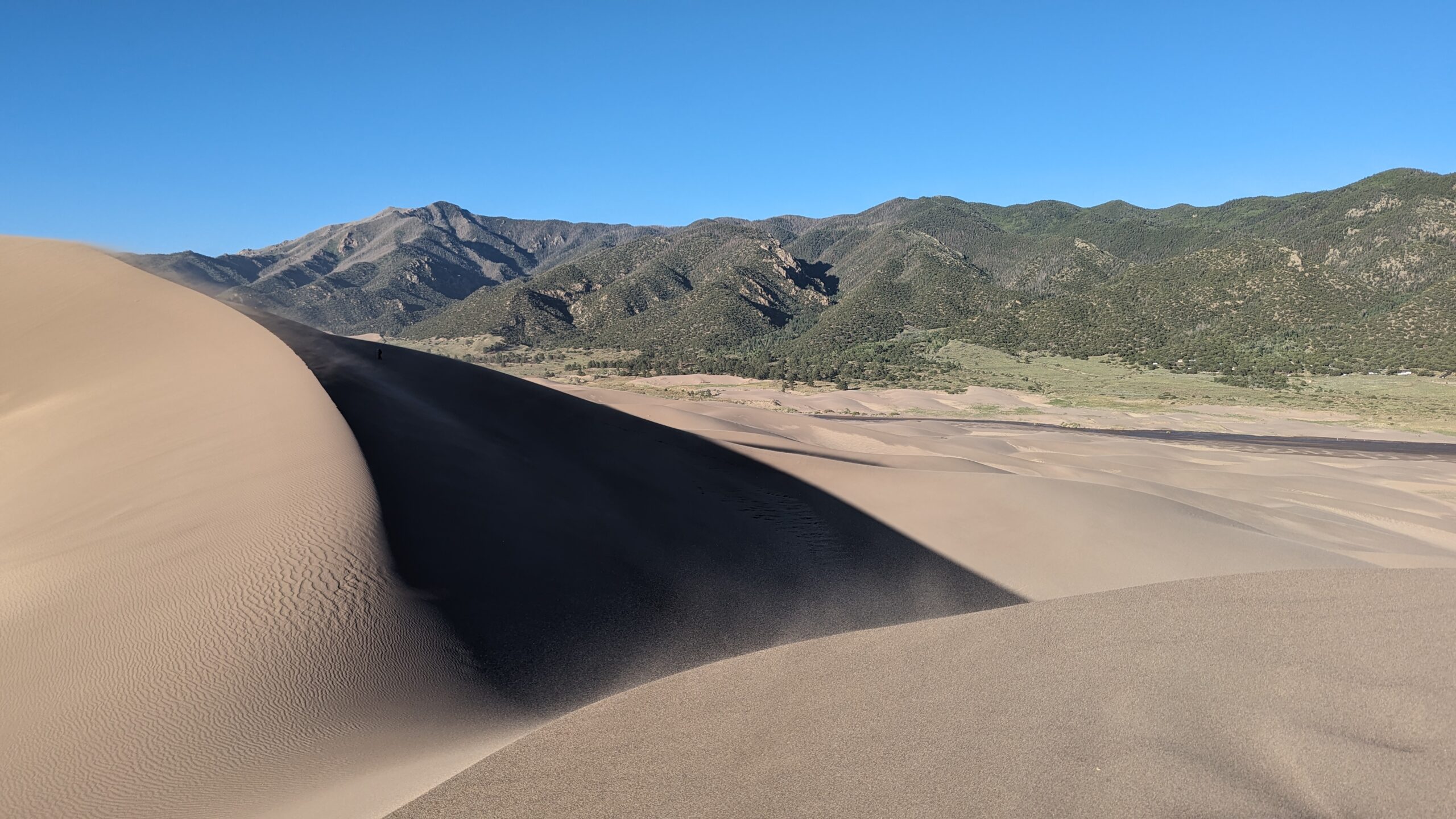 Tall sand dunes with mountains in the distance at Great Sand Dunes National Park